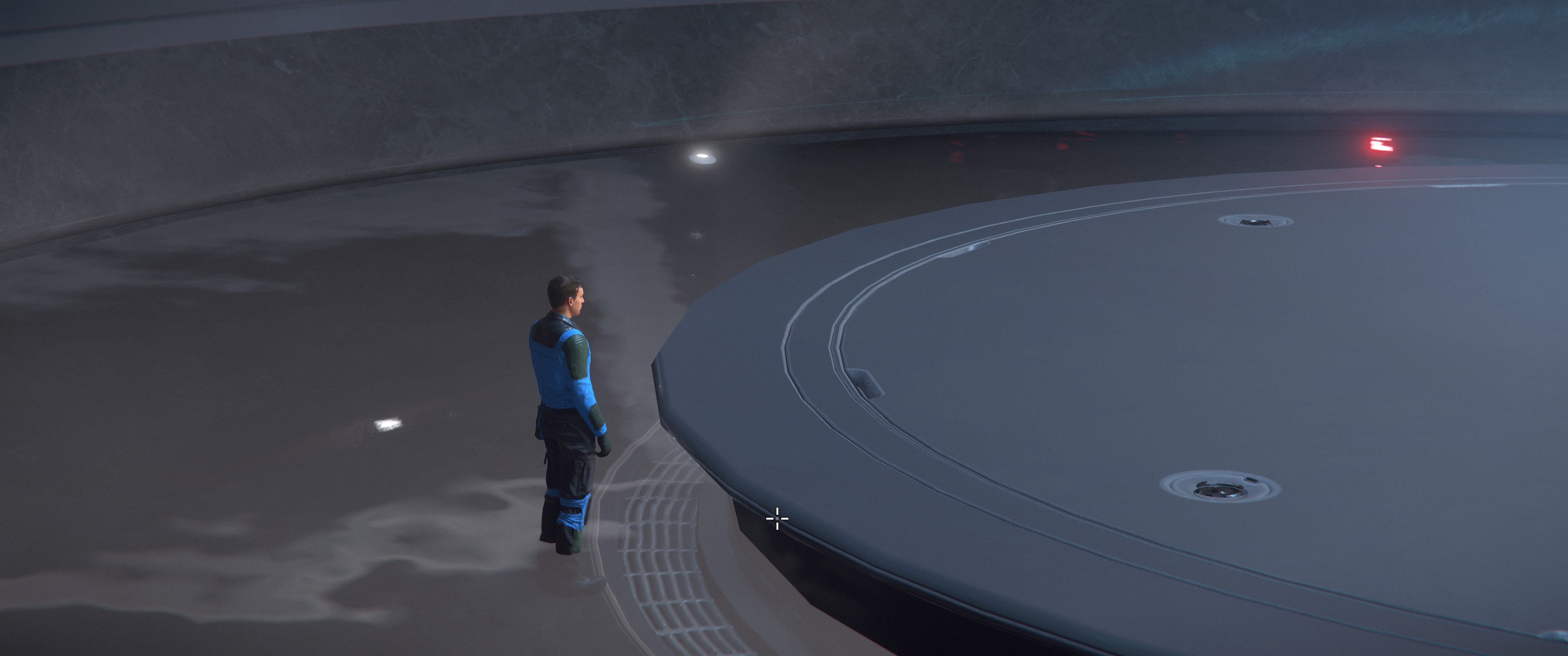 Zoomed view of a male NPC standing weirdly and motionlessly in what’s clearly a decorative pool, almost looking like he’s so lost in thought he wandered into the pool without realizing it